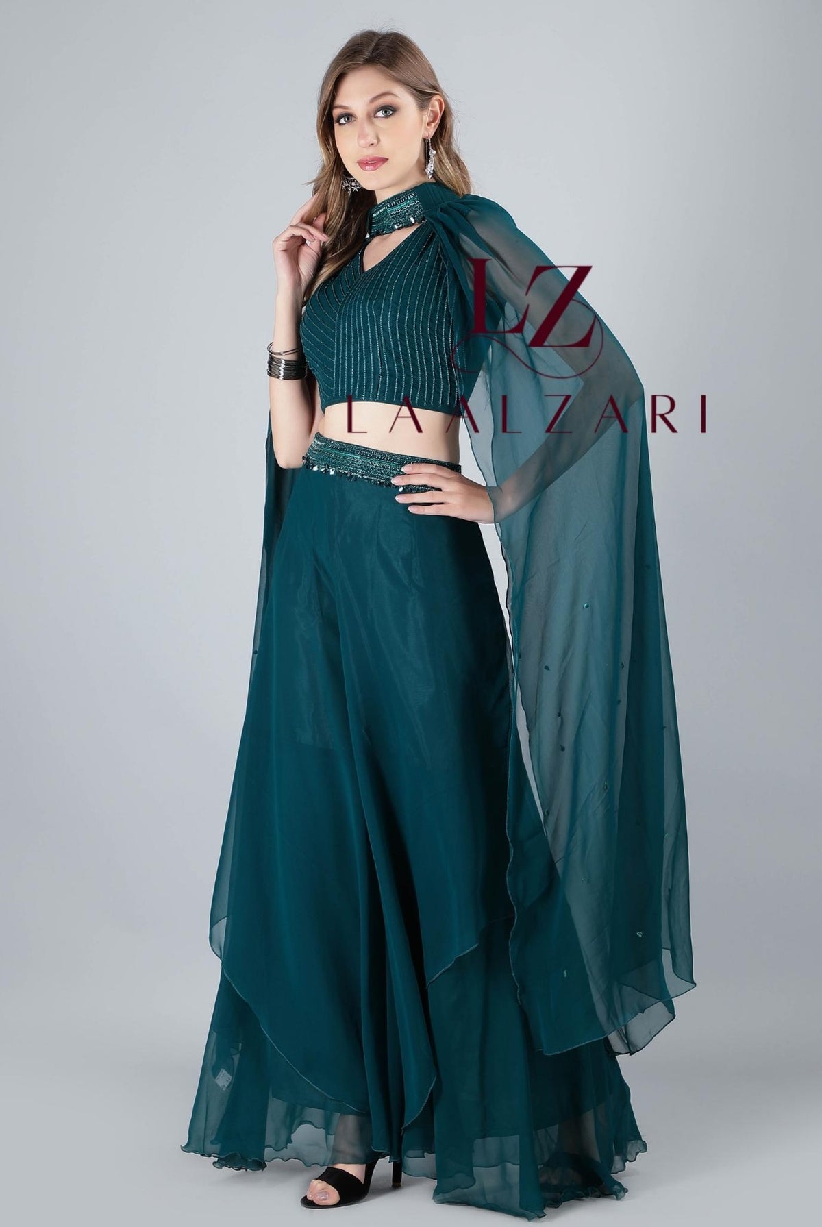 '-Featuring a classy teal embroidered crop top in an imported georgette fabric base with silky shiny black lustrous threads. It is paired with a matching subtle skirt with a designer veil.