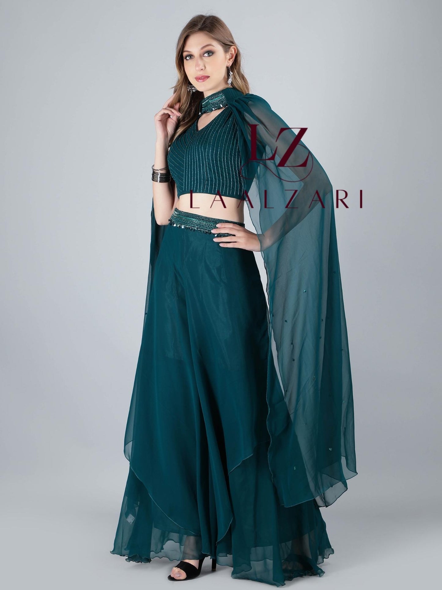 -Featuring a classy teal embroidered crop top in an imported georgette fabric base with silky shiny black lustrous threads. It is paired with a matching subtle skirt with a designer veil.