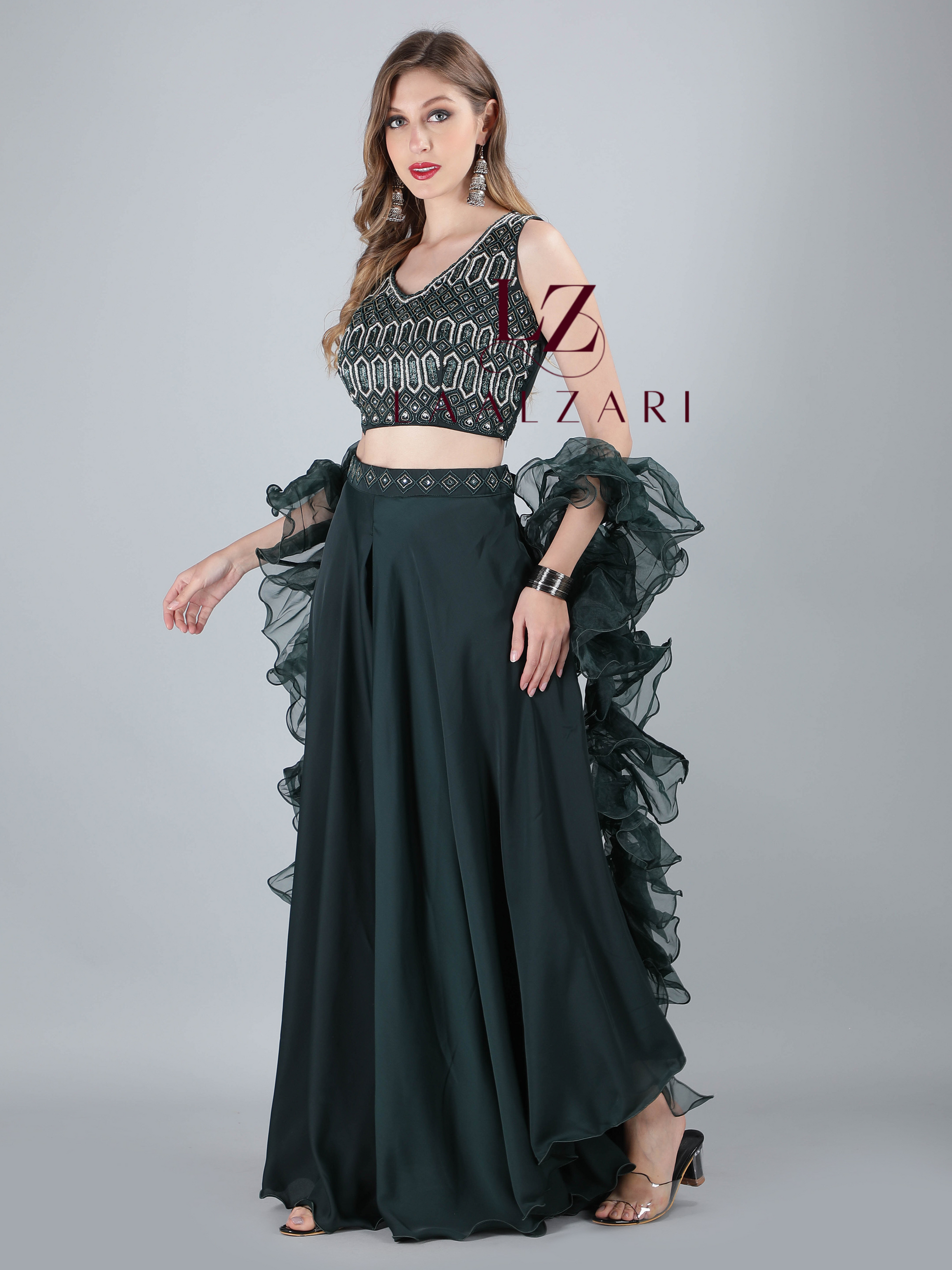 teal green structured trailing semi skirt paired with a sassy strappy crop- top and frilly contemporary dupatta